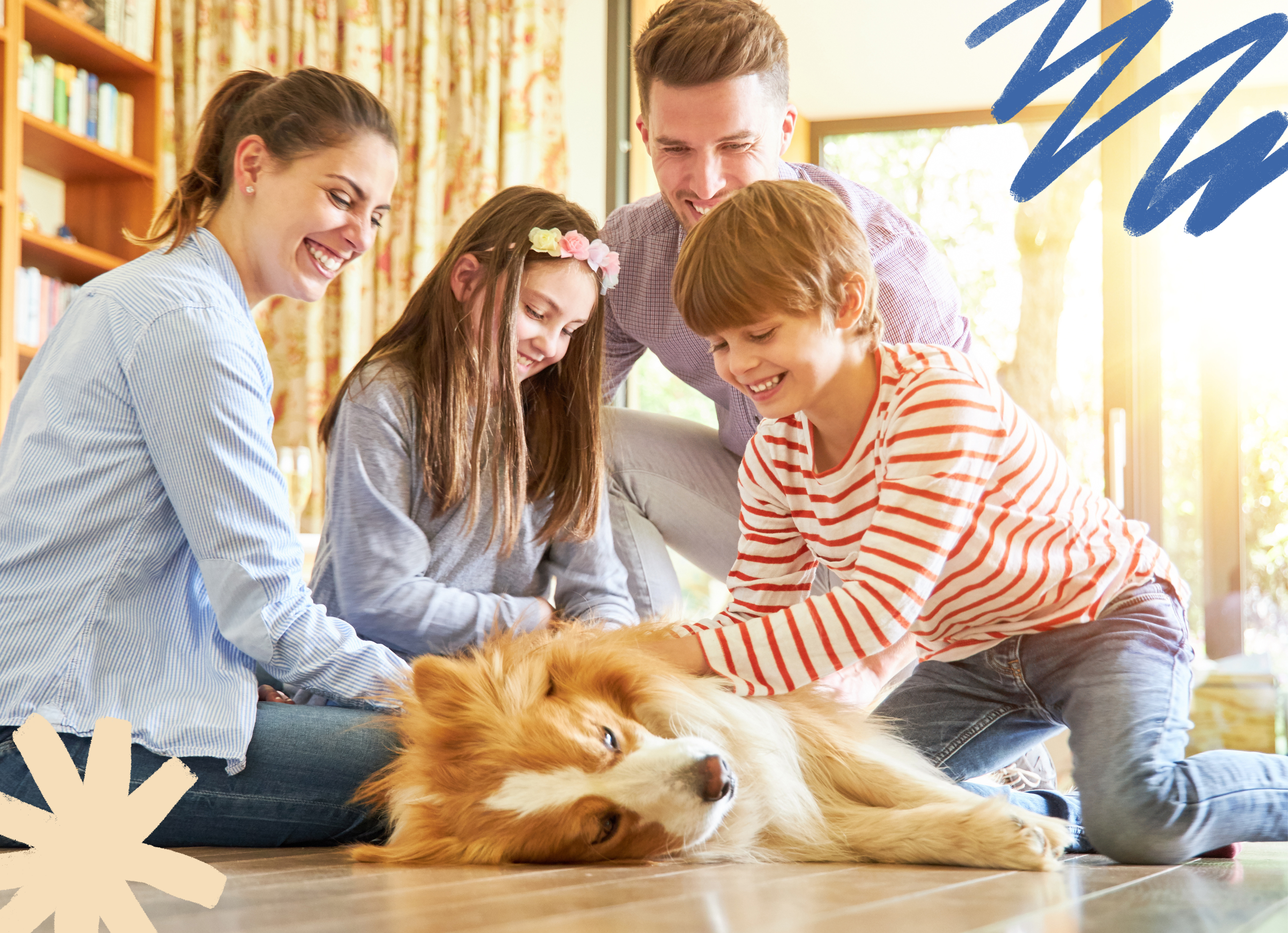 a family surrounding a tan and white dog as it lays on the ground and is being gently pet