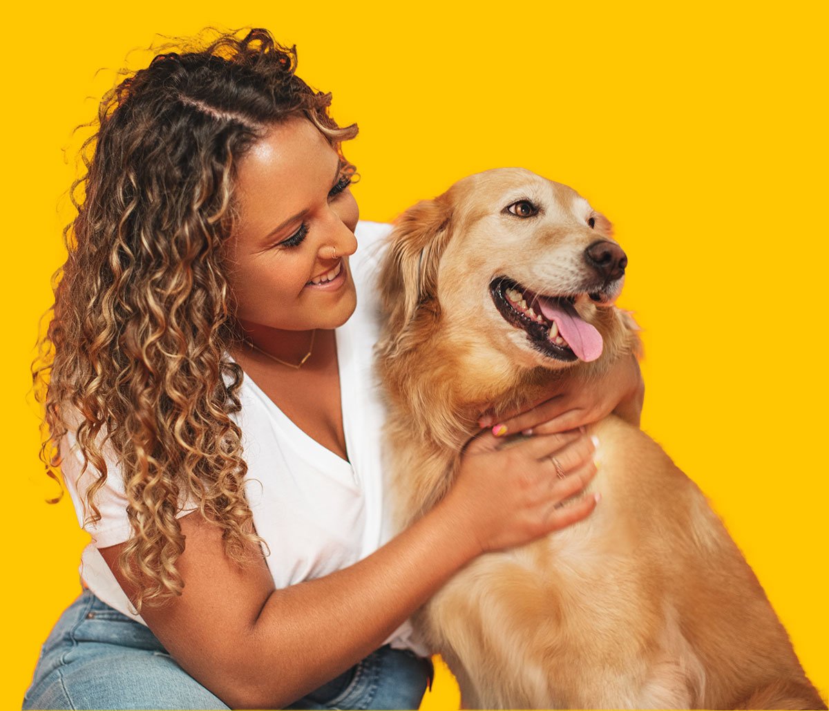 A woman hugging a golden retriever